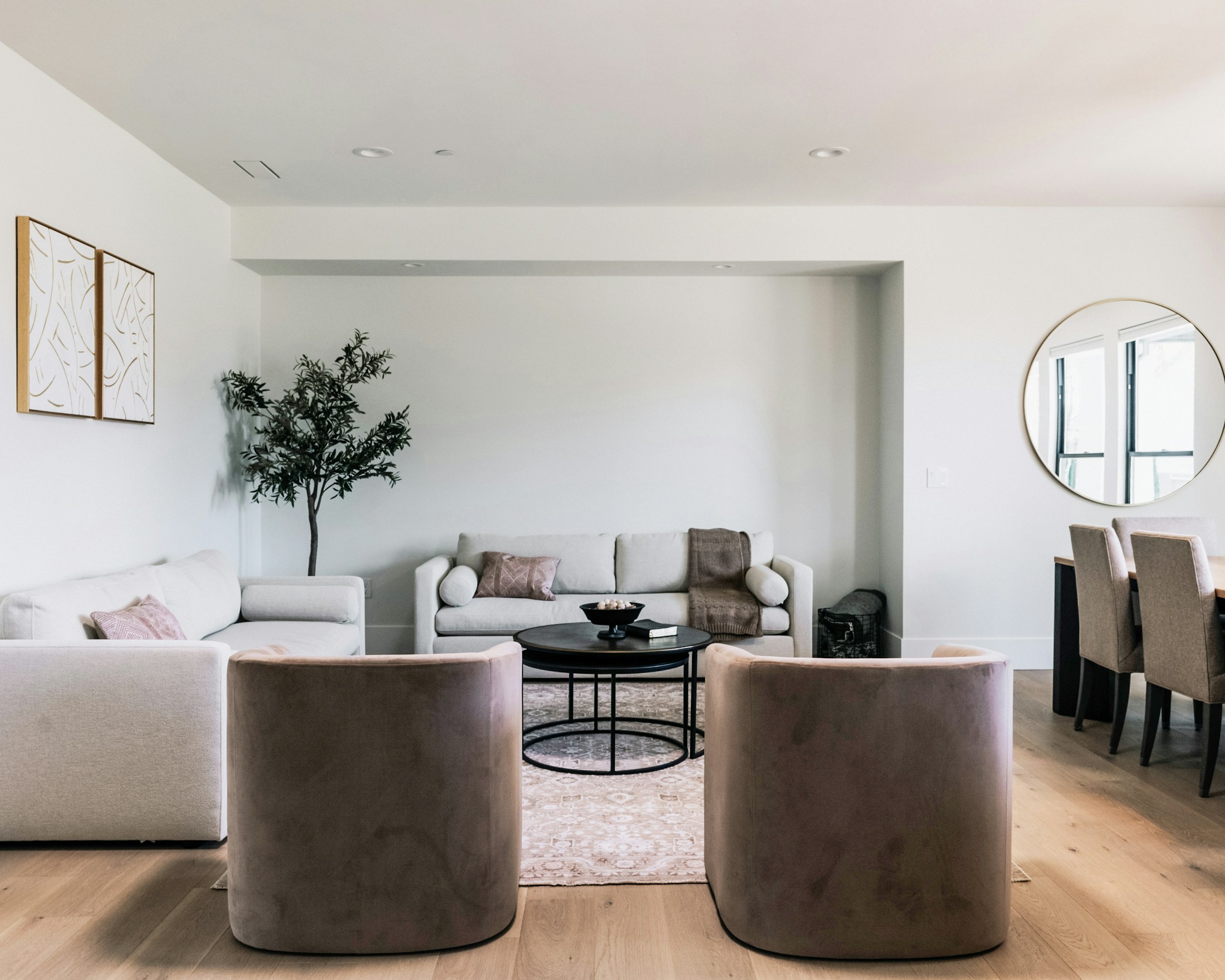 Sunlit contemporary living room with sculptural furniture and natural finishes